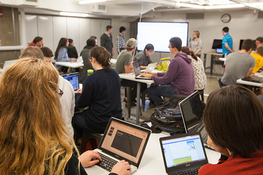 students in class with laptops